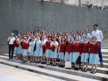 Sun Kei Girls’ Choir with Mr. WAN Cheuk-ning (right) and Mr. KWAN Yuk-lun (left) outside the competition venue