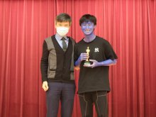 Principal Mr. HO Chun-yan (left) presenting the Best Performance Award in Senior Secondary Section to 4S class representative