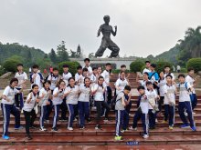 Students taking photo in front of Bruce Lee’s statue