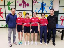 Participating female table tennis team members taking photo after the competition