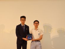 Alumnus Mr. LEE Waai-ngoi presents the symbolic badge of striving for excellent performance to fellow junior students, with WONG Shing-chun from 6M as the representative recipient