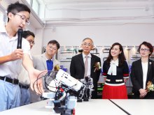 Mr. TSANG Fat-kuen, Manager of the IMC (L3), Mr. Terence CHAN, Secretary General of The Academy of Sciences of Hong Kong (R3), Principal Dr. POON Suk-han, Halina, MH (R2) and Ms. SO Wing-keun, Parent Manager of the IMC listening to the introduction of the robot design by students